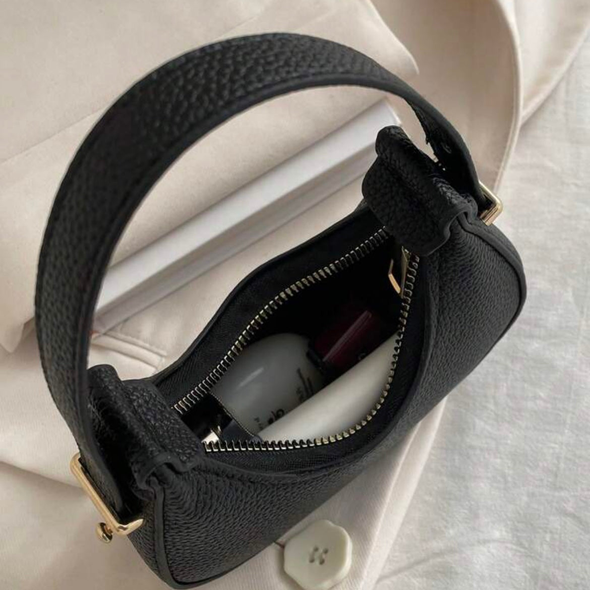 Black oval leather bag